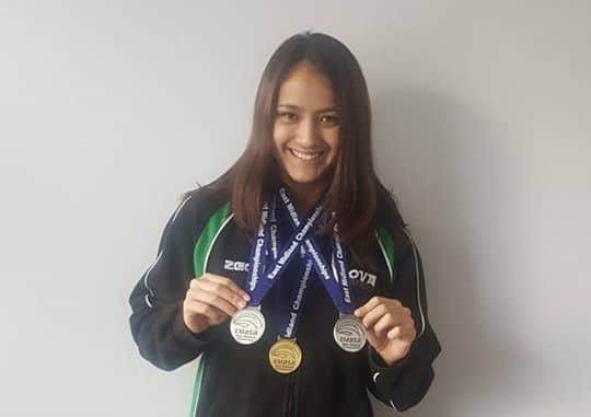 MEDAL HAT-TRICK -- Natalee Meldrum, of Sherwood SC, shows off her gold, silver and bronze medals.