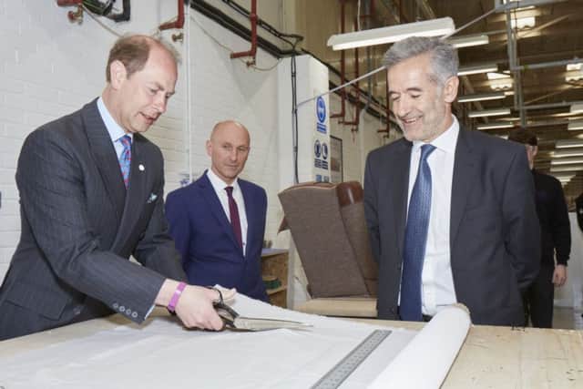 HRH tries his hand at fabric cutting with Ian Filby DFS CEO and DFS Training Manager Wayne Butler.