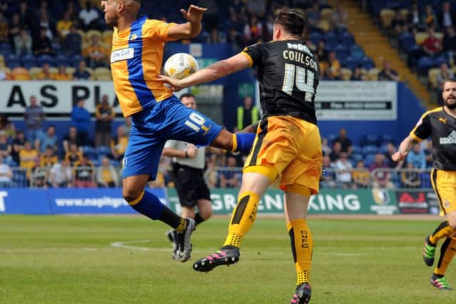 Mansfield Town v Cambridge Utd.Matt Green in first half aerial challenge.