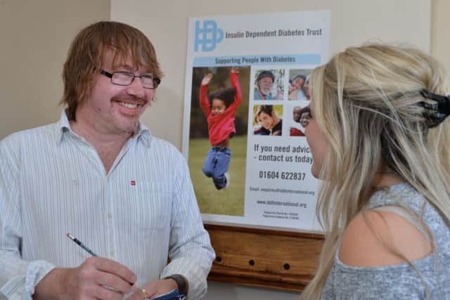Martin Hirst of the InDependent Diabetes Trust discusses the new booklet with a parent. Picture: Andrew Carpenter