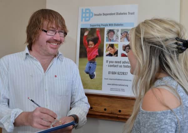 Martin Hirst of the InDependent Diabetes Trust discusses the new booklet with a parent. Picture: Andrew Carpenter