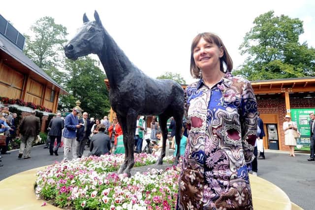 LADY AND THE CHAMP -- a statue of the mighty Frankel at York racecourse is admired by Lady Jane Cecil, widow of the wonder horse's late, great trainer, Sir Henry Cecil. Frankel's first foal won on debut last Friday.