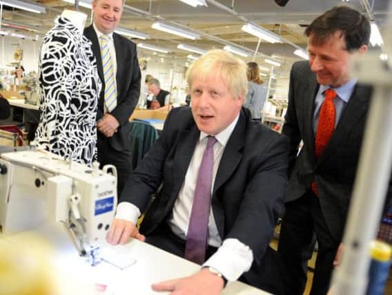 Boris Johnson on the Vote Leave campaign trail, with Alfreton clothes producer Christopher Neiper and Amber Valley MP Nigel Mills.