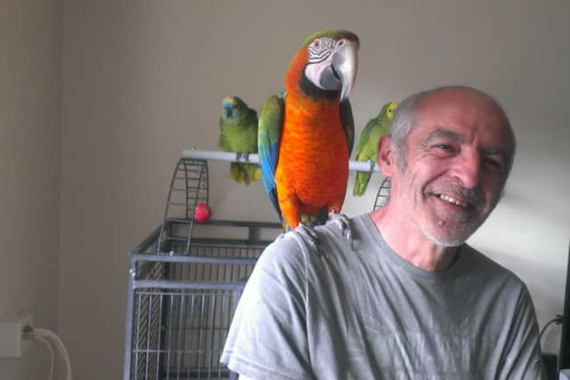 Derrick Buttigeg and Harley the parrot.