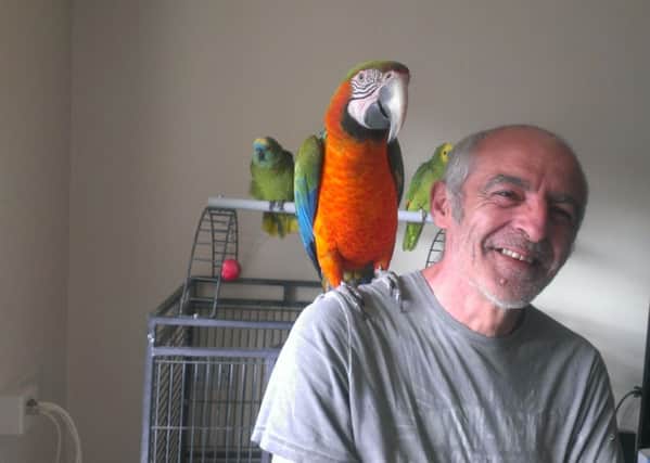 Derrick Buttigeg and Harley the parrot.