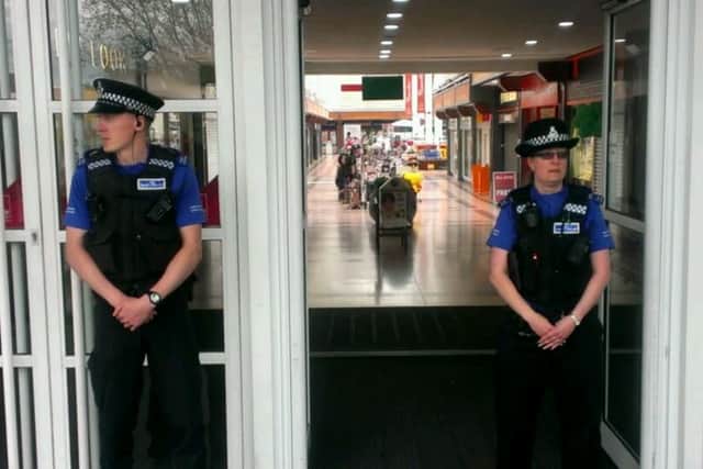 PCSOs guard an entrance to the cleared Idlewells.