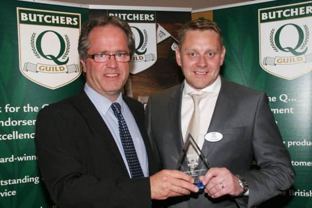 Scott, receiving his Q Guild award from chair John Howes