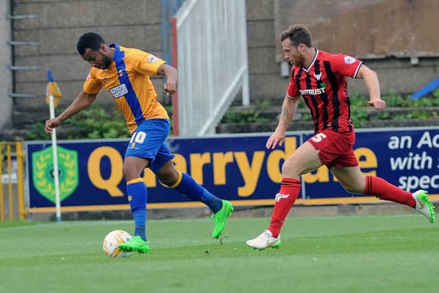 Mansfield's Matt Green gets free of Johnny Mullins during the home clash with Oxford last season.
