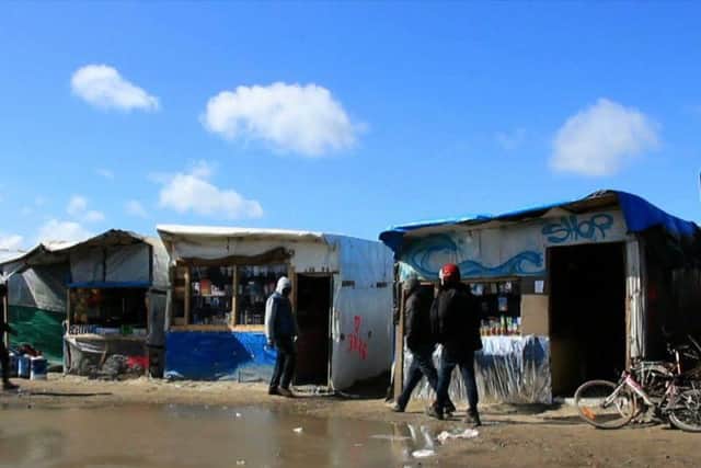A makeshift high street in the Calais Jungle - currently home to around 6,000 refugees from the Middle East and north Africa.
