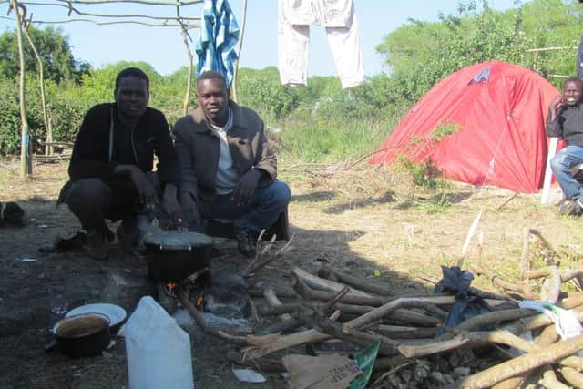 Two men at the Calais Jungle, photograph from May 2015. Image by Michal Blka (CC).