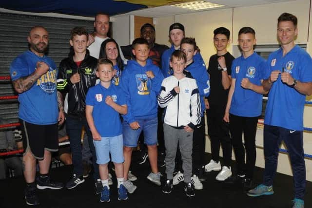 KNOCKOUT GUEST -- Nigel Benn (centre, back) with star-struck members of the Stags Boxing Academy.