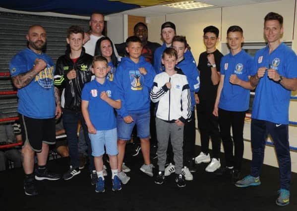KNOCKOUT GUEST -- Nigel Benn (centre, back) with star-struck members of the Stags Boxing Academy.