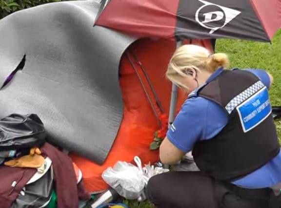A police officer finds the tent is locked from the outside. (Source: YouTube)