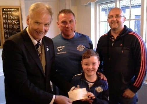 Rotary president Kevin Rostance, with coach John Cheetham, player Logan Scothern and Logan's dad Anthony