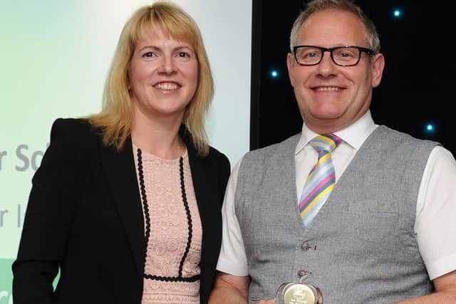 Graeme Brown is presented with the winners award for Best Breakfast/After School Club by Leysa Relf at the Chad Best in Schools 2016 awards. Picture: Andrew Roe