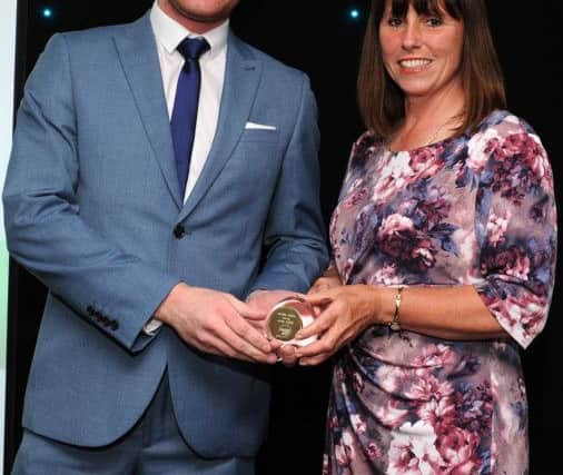 Debbie Aspinall is presented with the winners award for The Sports Award by Mark Stevenson at the Chad Best in Schools 2016 awards. Picture: Andrew Roe