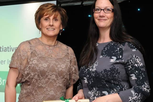 Rosey Honeyman-Smith is presented with the special recognition award for The Healthy Eating Initiative Award by Yvette Florence at the Chad Best in Schools 2016 awards. Picture: Andrew Roe