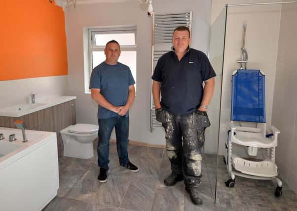 Mark Marshall has buillt a wetroom for his disabled son after getting fed up waiting for the council, Mark is
 pictured left  with James Kennedy, one of the builders who helped to install the bathroom