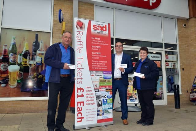Michael Holmes is campaigning to get defibrillators installed around Mansfield, pictured from left are One Stop shift manger Ian Eadson, Michael Holmes and shift manager Zara Byer