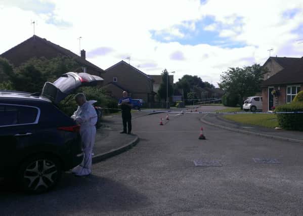 Crime scene investigators at Gleneagles Drive Kirkby this morning. The street was still cordoned off following Saturday's fatal stabbing.