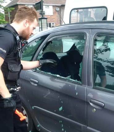 Notts police officer rescuing Gizmo from a hot car.