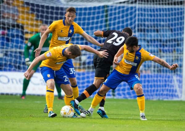 Mansfield Town vs Hull City - Jamie Mcguire and Chris Clements disposses Peter Odemwingie - Pic By James Williamson