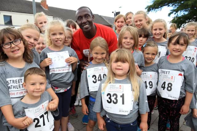 Kirkby Town Centre Street Athletics event with Linford Christie. Linford Christie is pictured with some off the competitors.