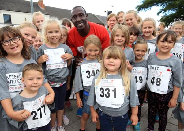 Kirkby Town Centre Street Athletics event with Linford Christie. Linford Christie is pictured with some off the competitors.