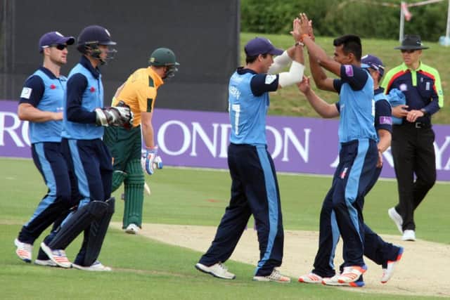 Derby Falcons Wayne Madsen and Shiv Thakor celebrate the fall of the wicket of Michael Lumb.