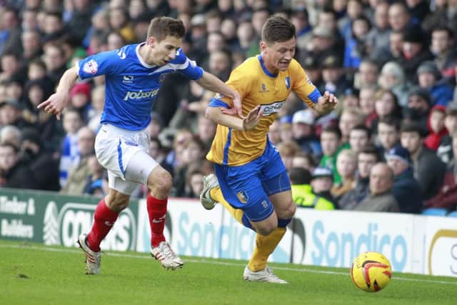 James Jennings skips past Pompey's Marcos Painter -Pic by: Richard Parkes
