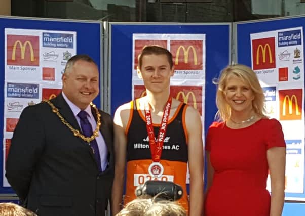 Milton Keynes' Mark Ryall receives his winners' medal at the end of today's Mansfield 10k race.
