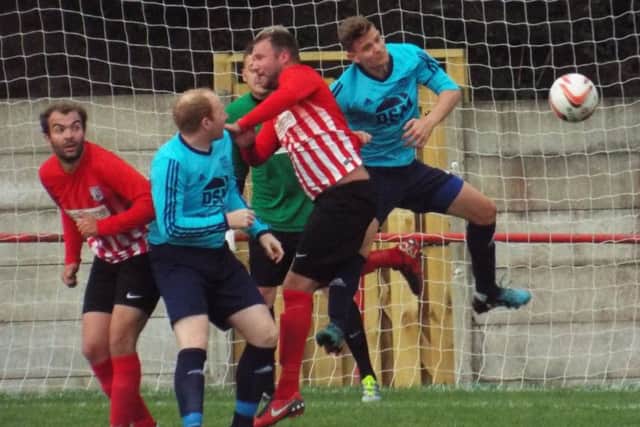 DESPERATE DEFENDING -- lots of bodies in the box in goalmouth action during the draw between Teversal and Penistone Church.