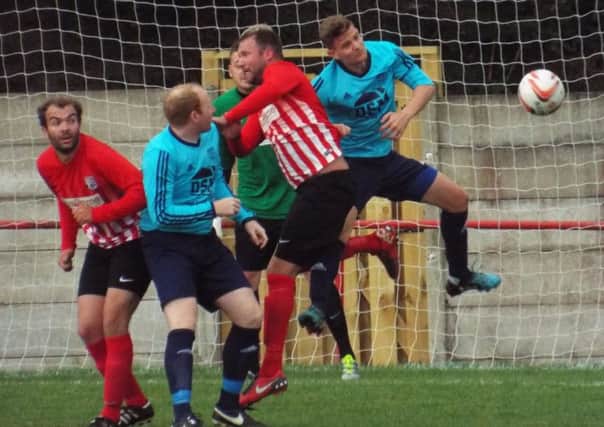 DESPERATE DEFENDING -- lots of bodies in the box in goalmouth action during the draw between Teversal and Penistone Church.