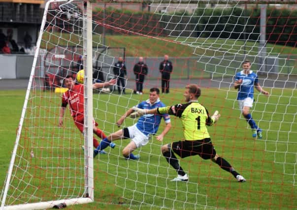 Ryan Williams gets a shot in for AFC Mansfield. Photo by Peter Craggs.