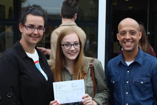 Manor's Charlotte Cropper, who achieved two A* and seven As, with  Miss Desforges deputy head of English and Mr Walters head of English.