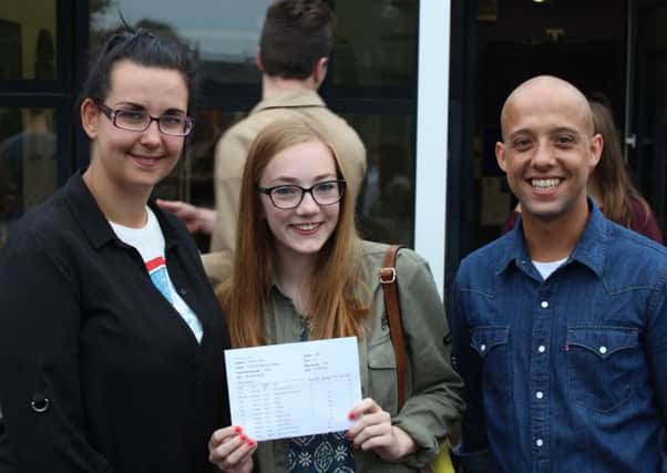 Manor's Charlotte Cropper, who achieved two A* and seven As, with  Miss Desforges deputy head of English and Mr Walters head of English.