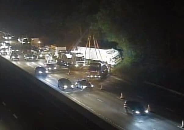 Work on Friday evening to recover the overturned lorry on the M1. Image: Highways England.