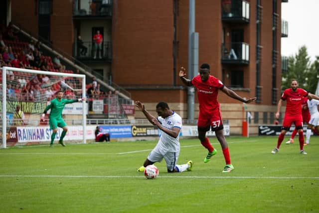 Mansfield Town's Krystian Pearce is brought down - Pic by Chris Holloway