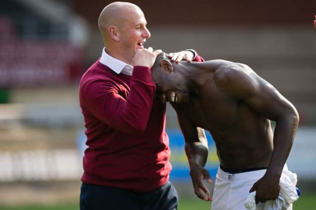 Mansfield Town's Manager Adam Murray congratulates goal scorer Mitchell Rose - Pic by Chris Holloway