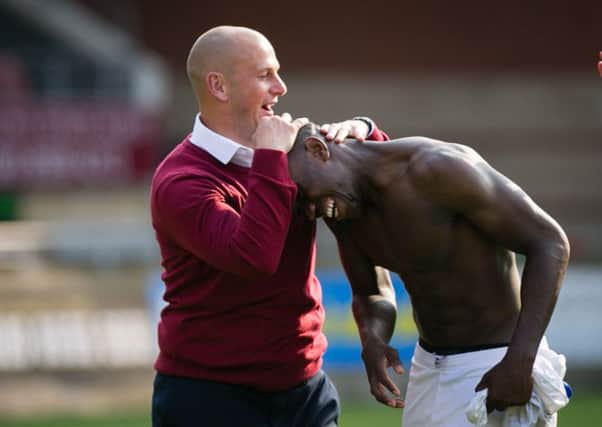 Mansfield Town's Manager Adam Murray congratulates goal scorer Mitchell Rose - Pic by Chris Holloway