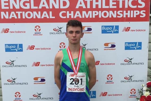 SILVER SERVICE -- Mansfield Harrier Luke Duffy with the silver medal he won at the national championships.