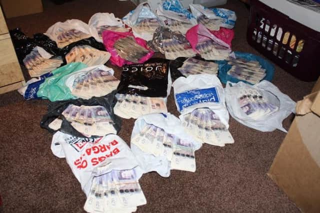 HMRC officers raided their property in December 2014 and seized Â£97,765 in cash, which was found in carrier bags.