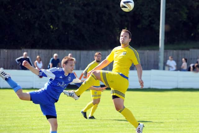 Pinxton v Selston.Jamie Renshaw beats Timmy Adcock to the ball at Wharf Road on Monday.