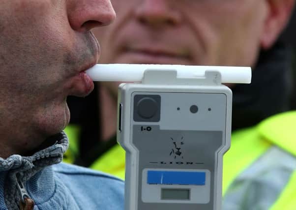 A man being breathalysed. Picture posed by a model