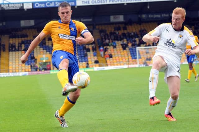 Mansfield Town v CambridgeStags' captain, Lee Collins, puts the last cross of the first half into the Cambridge box.