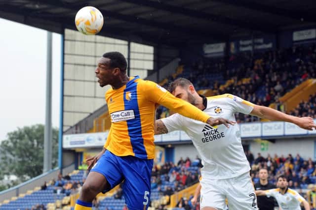Mansfield Town v CambridgeKrystian Pearce beats Greg Taylor to an edge of the box header.