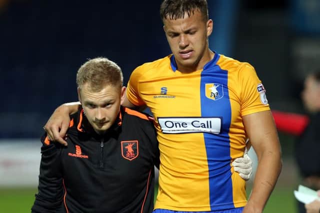 Mansfield Town's Kyle Howkins is helped off injured against Doncaster Rovers.
Picture by Dan Westwell