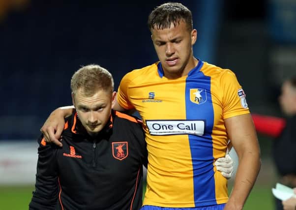 Mansfield Town's Kyle Howkins is helped off injured against Doncaster Rovers.
Picture by Dan Westwell