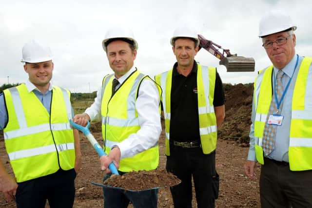 Managing director Pat Kelly, cuts the sod to officially get work underway on the new home for the Wood Lane Timber Merchants on Butlers Hill Industrial Estate on Tuesday, watched by from left, Coun. Ben Bradley, site manager of Vaughandale Construction Alan Connor and Coun. Mick Murphy.