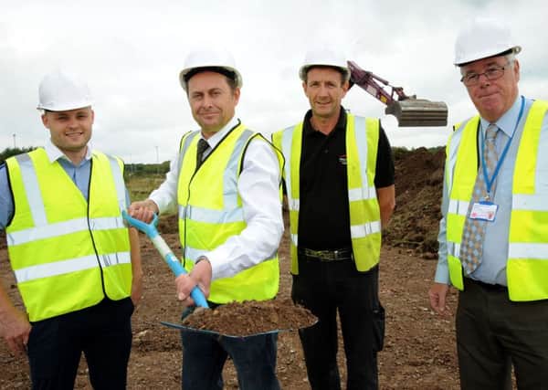 Managing director Pat Kelly, cuts the sod to officially get work underway on the new home for the Wood Lane Timber Merchants on Butlers Hill Industrial Estate on Tuesday, watched by from left, Coun. Ben Bradley, site manager of Vaughandale Construction Alan Connor and Coun. Mick Murphy.